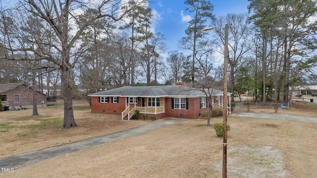 205 Woodside Dr, Goldsboro, NC 27534 - view of front of house featuring a gate, fence, concrete driveway, crawl space, and brick siding