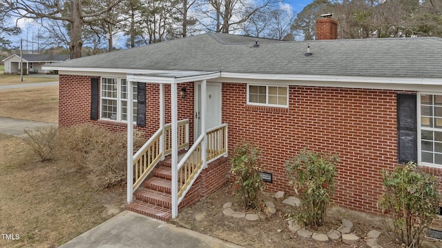 205 Woodside Dr, Goldsboro, NC 27534 - view of front of home featuring brick siding, a chimney, and roof with shingles