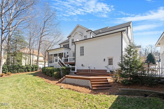 back of house with fence, a wooden deck, a sunroom, stairs, and a lawn