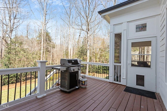 wooden deck with a grill