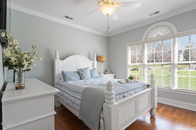 bedroom featuring crown molding, wood finished floors, visible vents, and baseboards