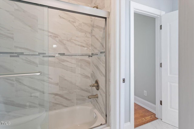 full bathroom featuring baseboards and enclosed tub / shower combo