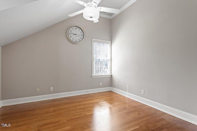 empty room with lofted ceiling, light wood-type flooring, baseboards, and ceiling fan