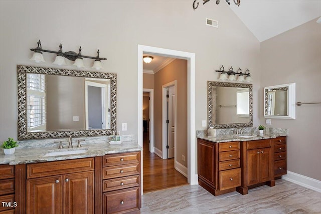 full bathroom featuring a sink, visible vents, baseboards, and two vanities