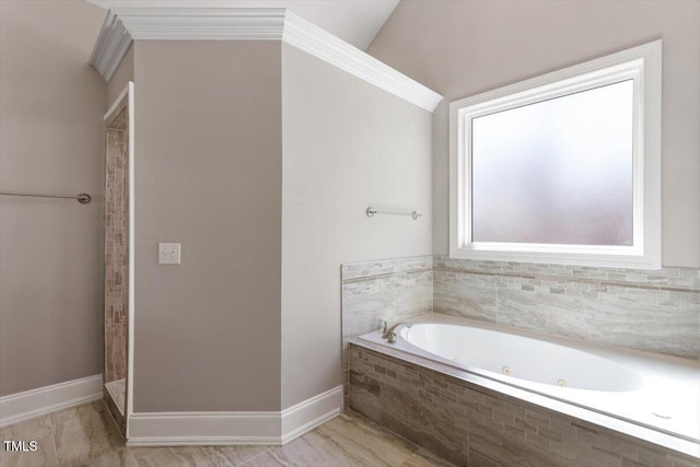 full bathroom with baseboards, a tub with jets, and a tile shower