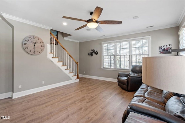 living area with stairs, light wood-type flooring, visible vents, and crown molding