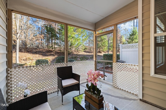 sunroom featuring vaulted ceiling