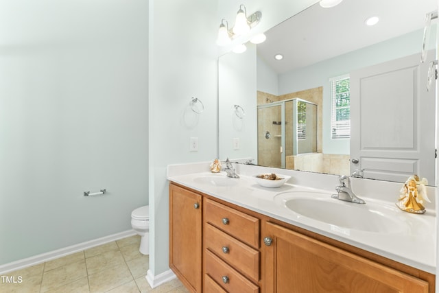 full bath with a sink, toilet, a shower stall, and tile patterned flooring