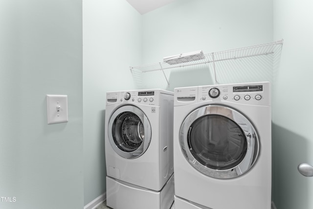 laundry room featuring baseboards, washing machine and dryer, and laundry area