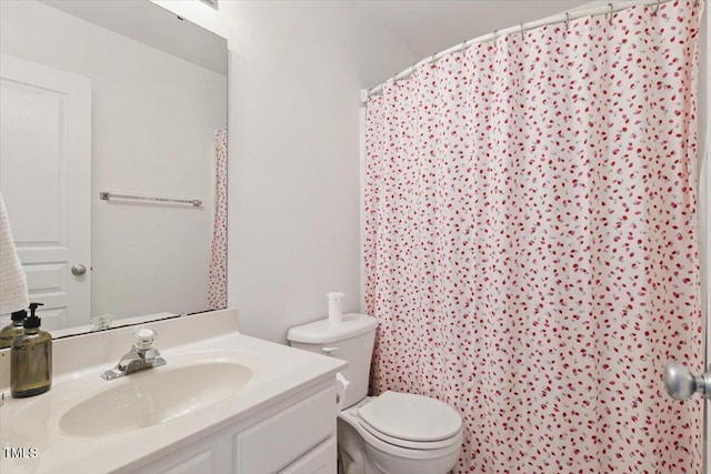 bathroom featuring toilet and vanity