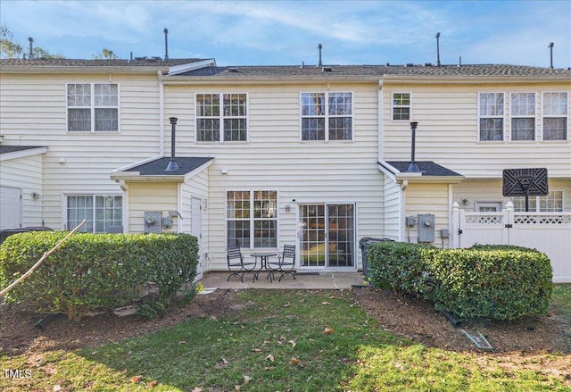 rear view of house with a patio area and fence