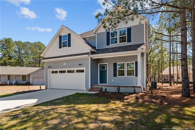 view of front of house featuring roof with shingles, concrete driveway, and a front yard