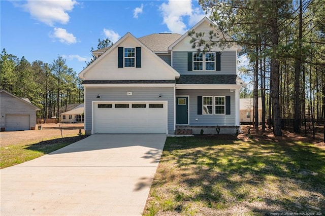 view of front of house with a front lawn, concrete driveway, a garage, and roof with shingles