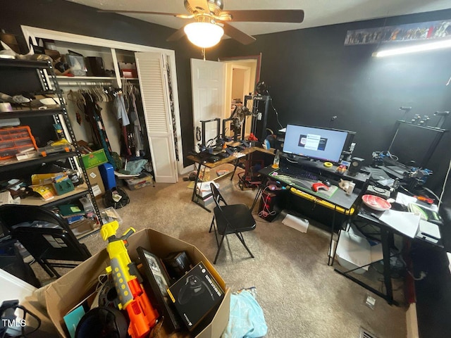 carpeted office featuring a ceiling fan