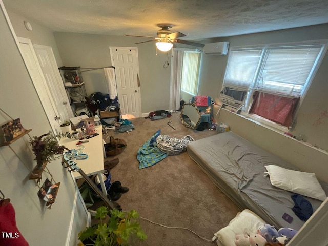 bedroom with a textured ceiling, a ceiling fan, a wall mounted air conditioner, and carpet floors