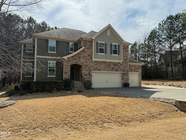 view of front facade featuring cooling unit, a shingled roof, concrete driveway, a garage, and stone siding