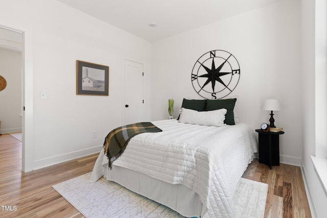 bedroom with baseboards and light wood-style floors