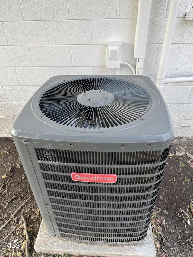 exterior details with central AC unit and concrete block siding