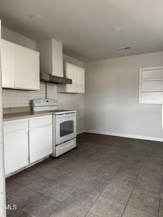 kitchen featuring visible vents, white electric stove, white cabinetry, wall chimney exhaust hood, and tasteful backsplash