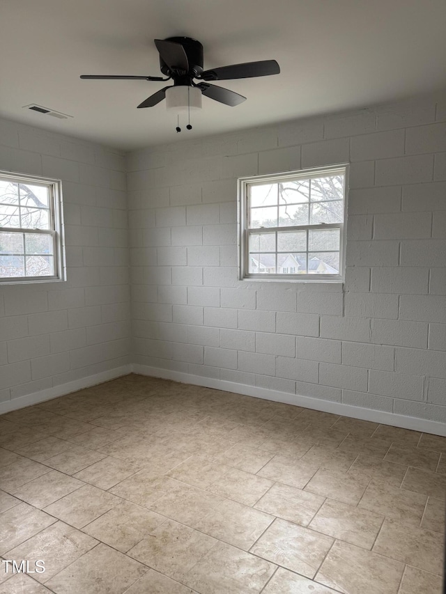 unfurnished room with a ceiling fan and visible vents