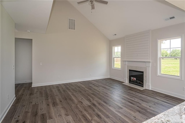 5815 James Allen Ln, Stedman, NC 28391 - unfurnished living room featuring a ceiling fan, high vaulted ceiling, dark wood-style flooring, a high end fireplace, and baseboards
