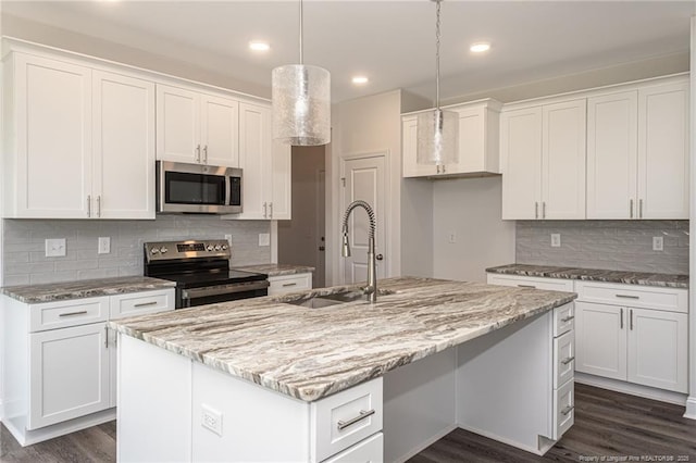 5815 James Allen Ln, Stedman, NC 28391 - kitchen featuring appliances with stainless steel finishes, a sink, a center island with sink, white cabinetry, and dark wood-style flooring