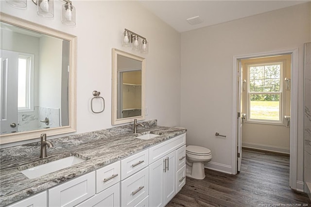 5815 James Allen Ln, Stedman, NC 28391 - full bathroom featuring healthy amount of natural light, toilet, double vanity, and wood finished floors