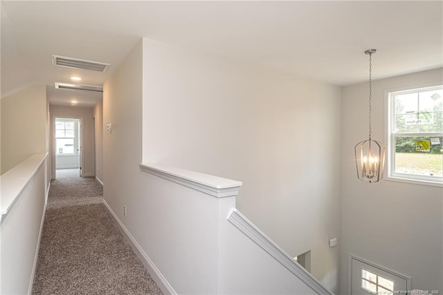 5815 James Allen Ln, Stedman, NC 28391 - hallway featuring an upstairs landing, a chandelier, carpet flooring, and baseboards