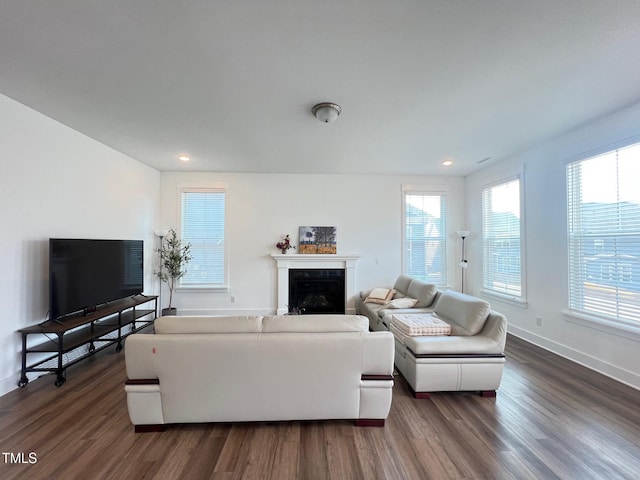 living room with dark wood finished floors, recessed lighting, a fireplace, and baseboards