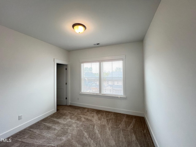 unfurnished room featuring visible vents, carpet flooring, and baseboards