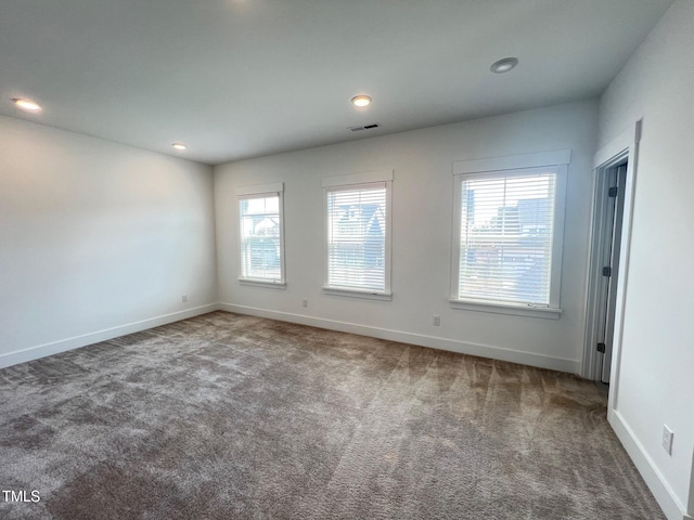 empty room featuring recessed lighting, visible vents, carpet floors, and baseboards