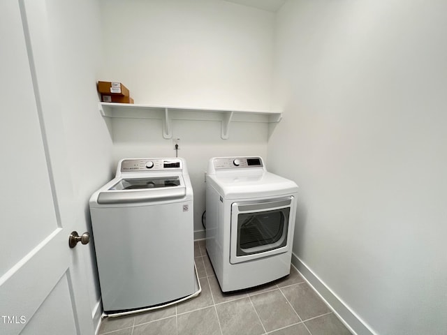 laundry room with tile patterned floors, laundry area, independent washer and dryer, and baseboards