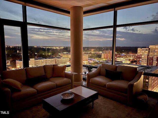 living room featuring a wall of windows and a city view