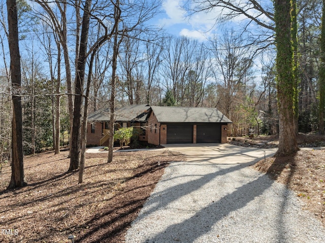 view of front of house featuring a garage, brick siding, and driveway