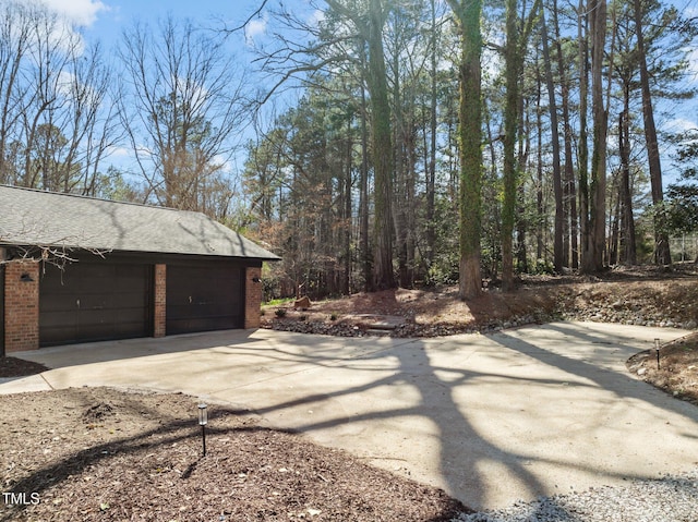 garage featuring concrete driveway