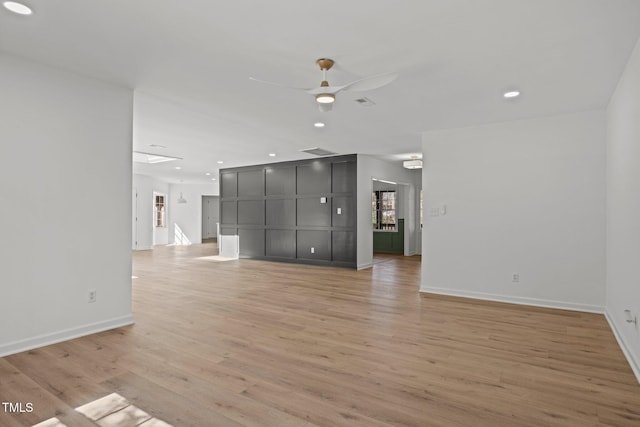 unfurnished living room with baseboards, recessed lighting, a ceiling fan, and light wood-style floors