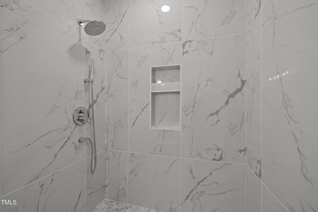 full bathroom with a marble finish shower