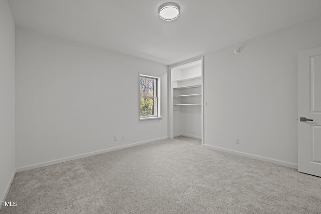 unfurnished bedroom with a closet, baseboards, and carpet floors