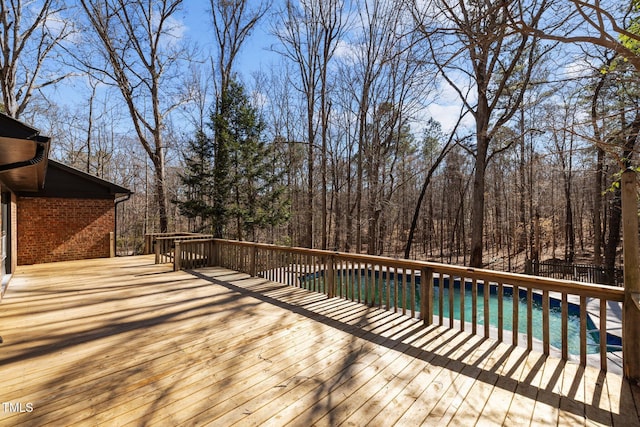 wooden deck featuring an outdoor pool