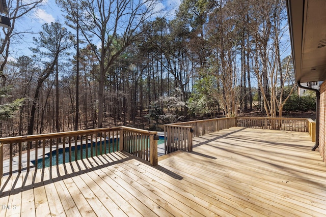 wooden terrace with an outdoor pool