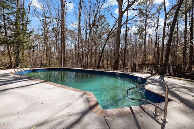 outdoor pool with a patio area