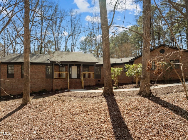 exterior space featuring brick siding and covered porch