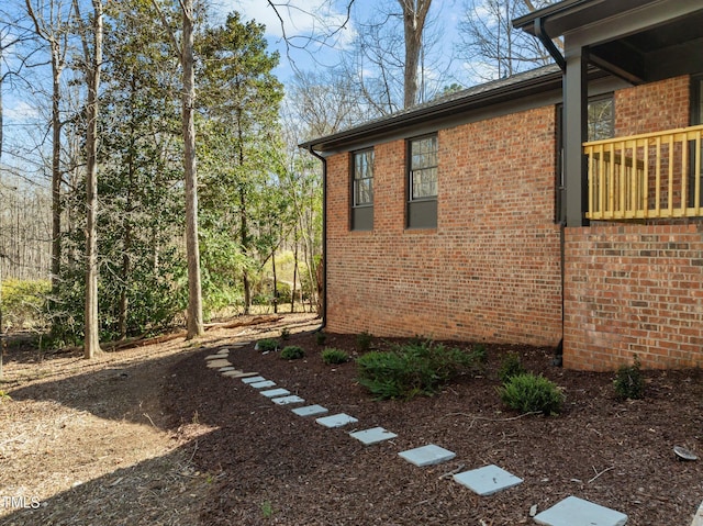 view of side of property featuring brick siding