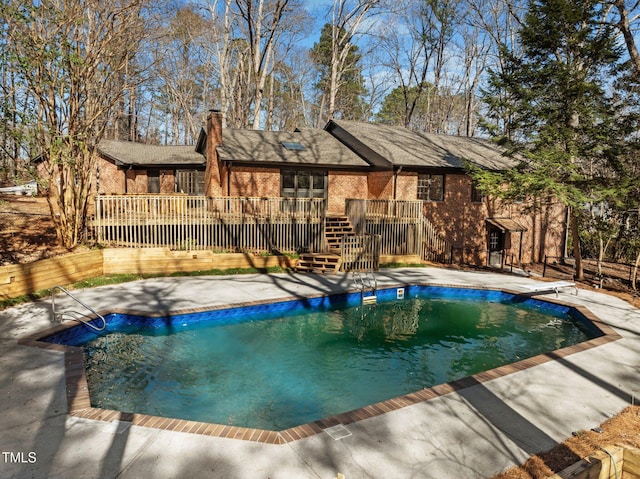 pool featuring a wooden deck and a patio