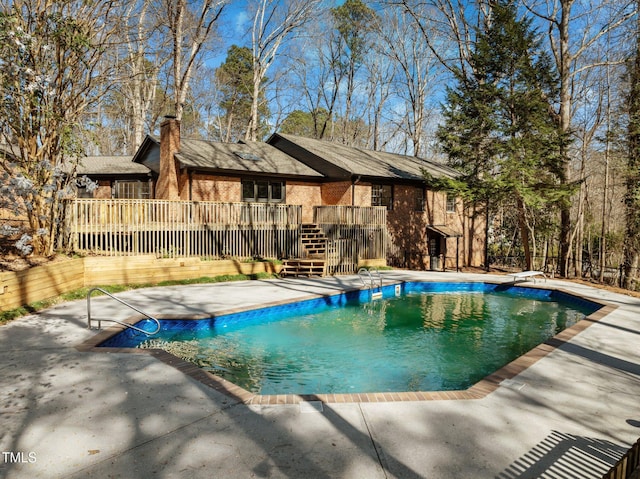 view of swimming pool featuring a deck, a patio, and a fenced in pool