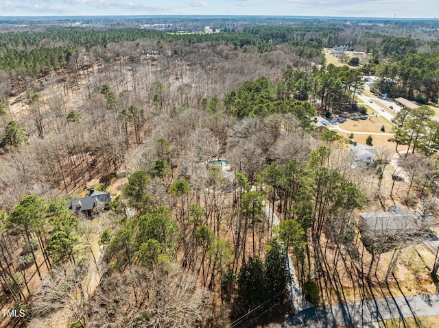 aerial view featuring a wooded view