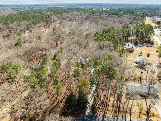 birds eye view of property with a view of trees