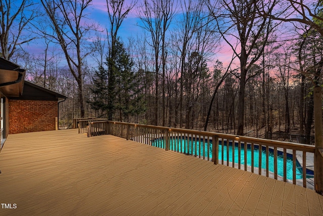 outdoor pool with a wooden deck