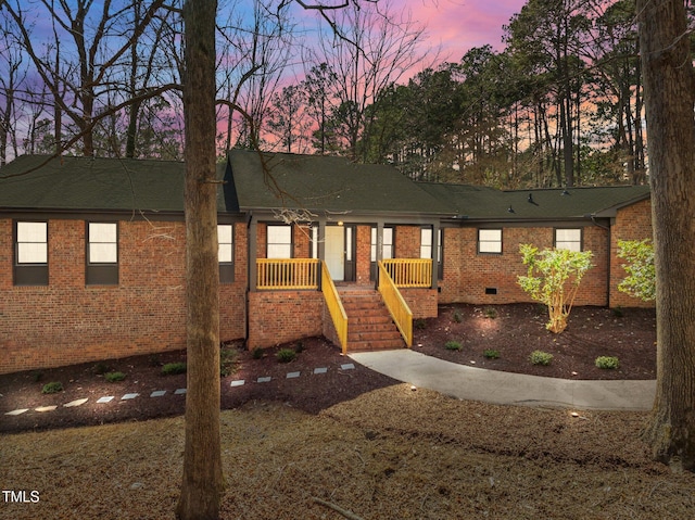 single story home featuring brick siding and a shingled roof