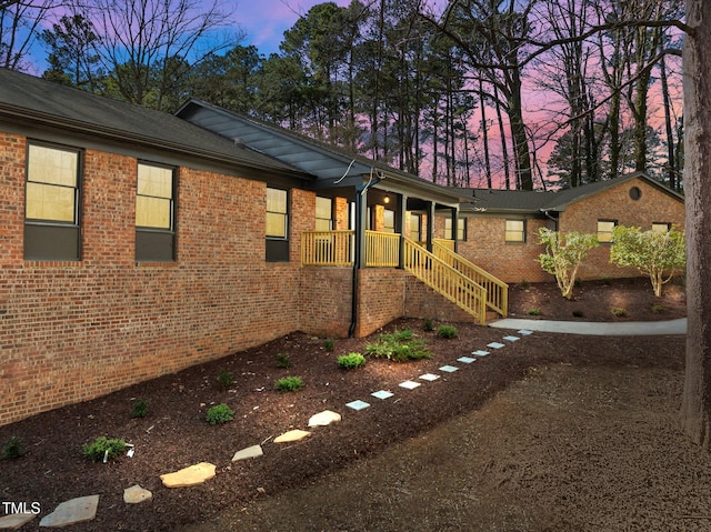 view of side of property featuring brick siding